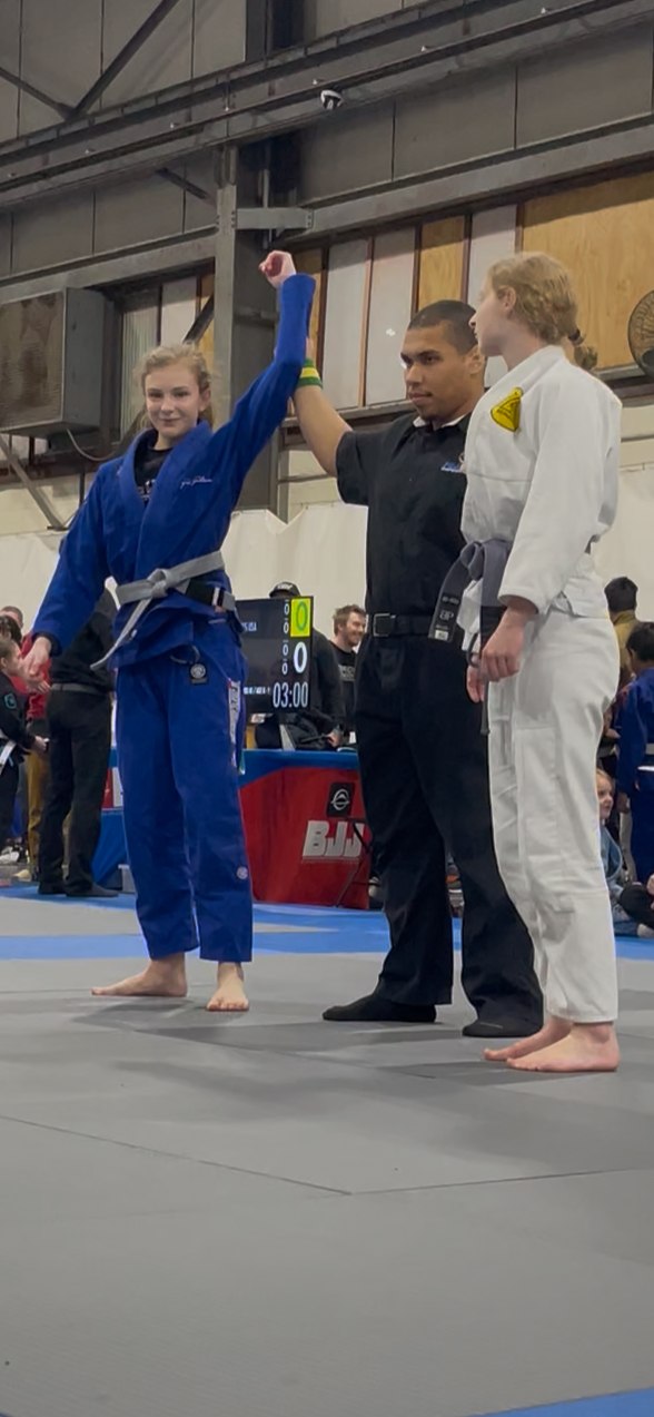 Miley's hand being raised after a competition win
